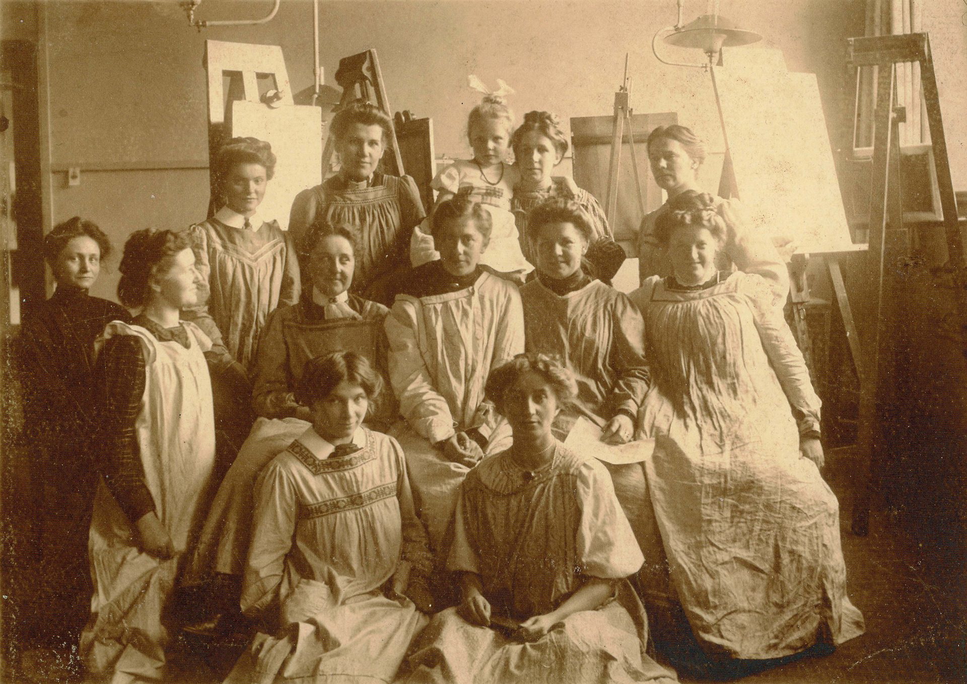 Sepia-coloured photograph of female students in a classroom.