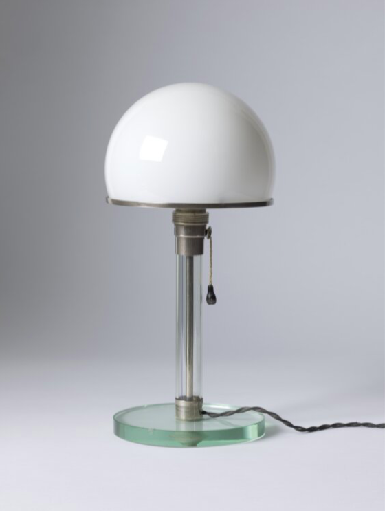 The base and stem are made of glass, with a frosted glass dome framed by a metal band serving as a reflector. The cable is concealed in a metal tube enclosed by the glass cylinder.