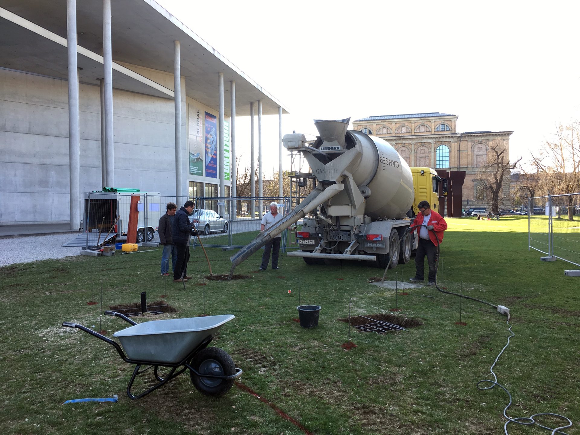 The concrete is being poured into the holes.