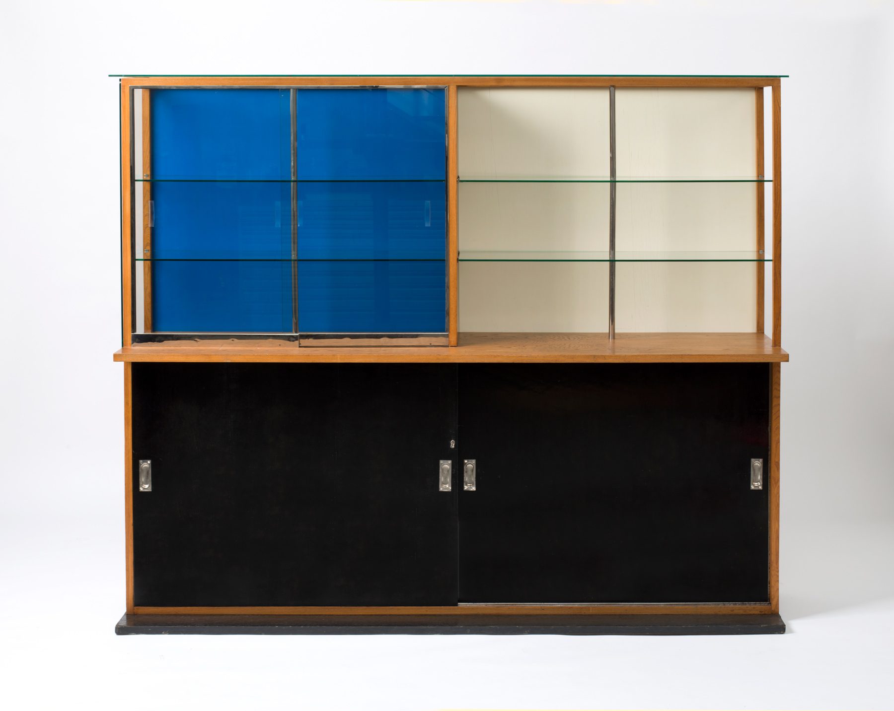 Wardrobe divided into four squares top left blue, right white. Both have sliding glass doors and shelves. Two sliding doors in black at the bottom.